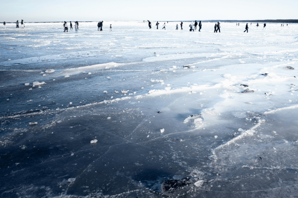 Visitors walking on the frozen sea ice during an icebreaker cruise stop